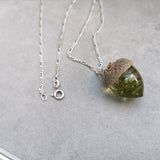 Acorn necklace with real moss, on leather cord